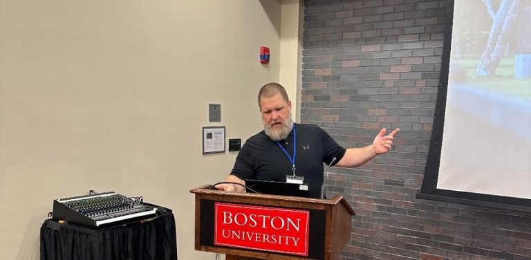 Daniel Soucier stands at Boston University podium during a presentation.