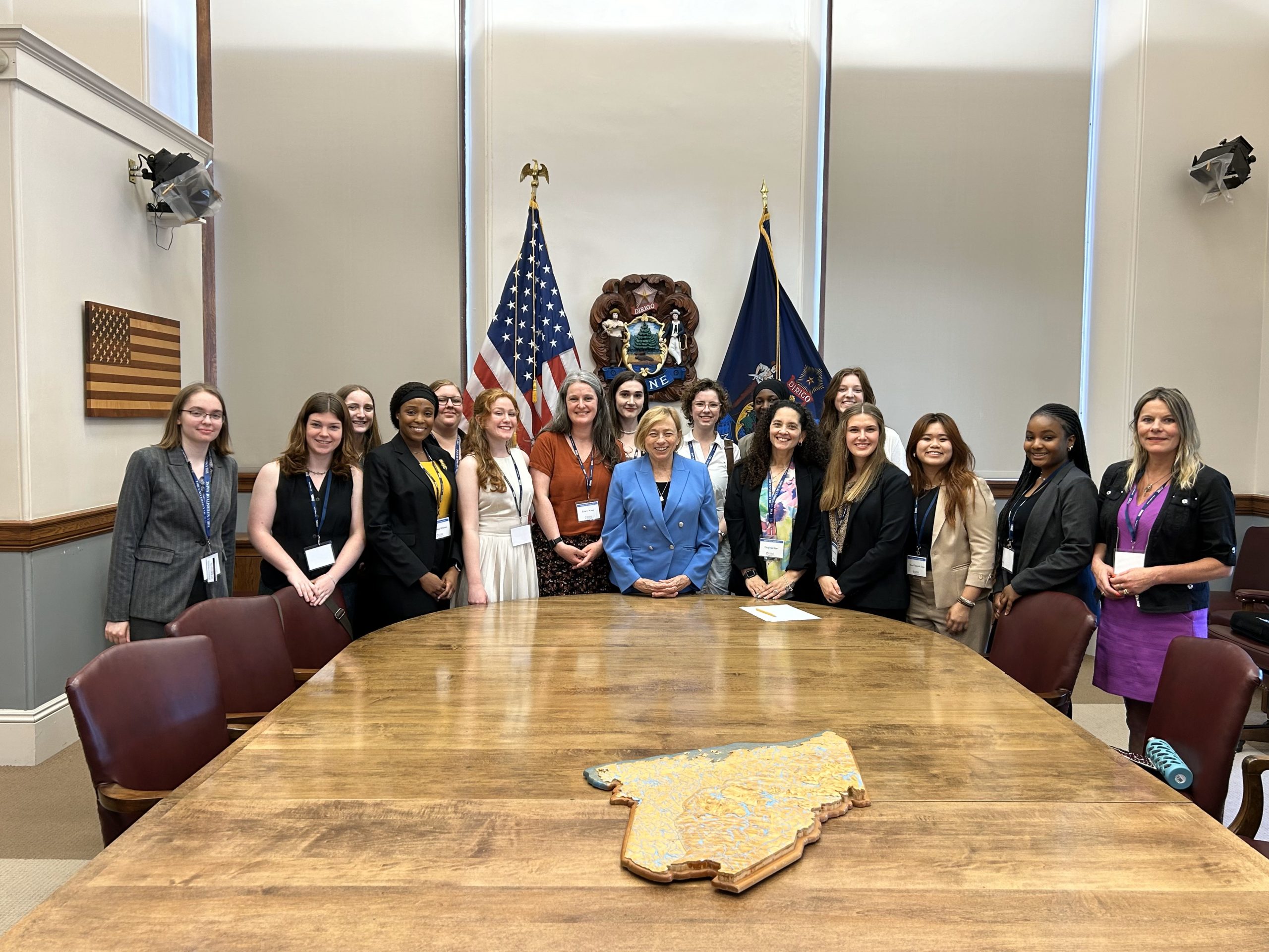 Governor Janet Mills with Maine NEW Leadership participants standing around large conference table.