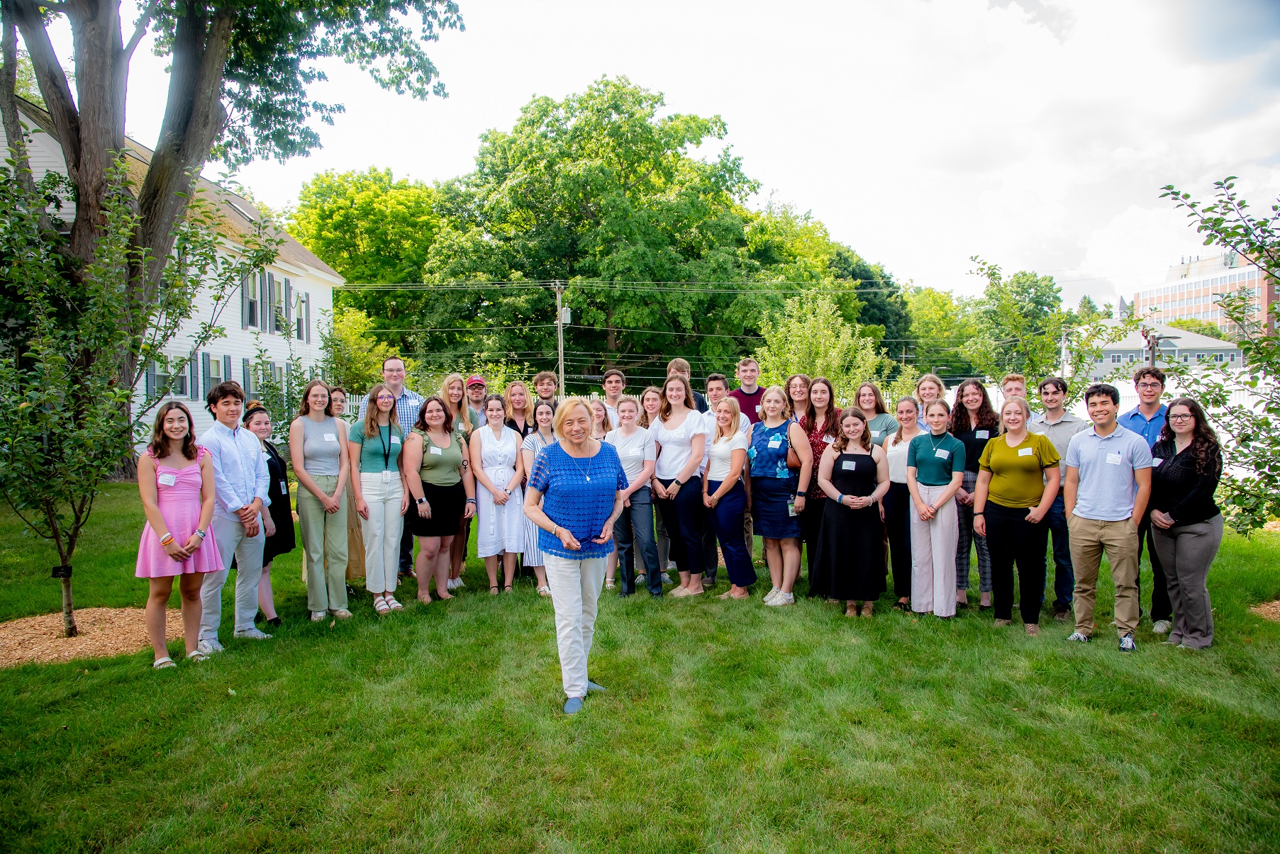 Governor Janet Mills stands on the lawn of the Blaine House in front of the 2024 Government Interns